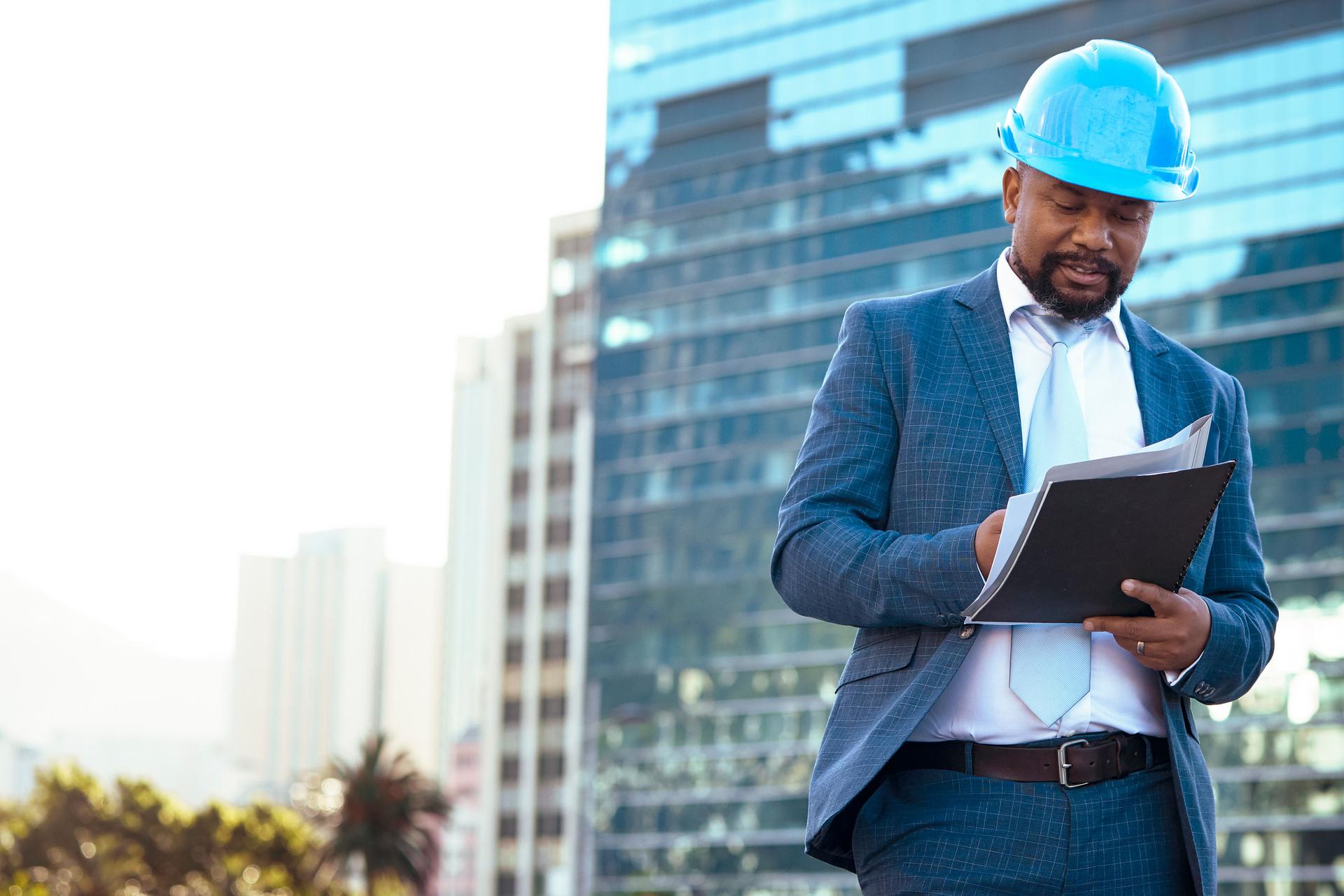 Businessman looking at his new building plan